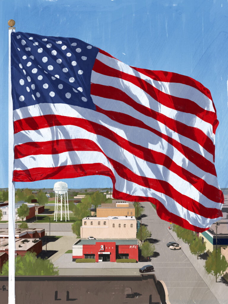 USA:s flagga blåser i vinden och i bakgrunden finns en klassisk amerikansk landsort.